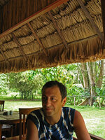 Pascal Héni protected by a roof made of thatched Licuala spinosa leaves, Havelock, Andaman Islands