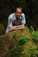 Patrick Blanc above a mossy rock covered by the shiny leaved rheophytic Bakoa lucens, Bako, Sarawak, Borneo, July 2010