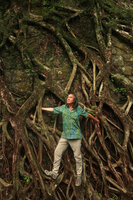 Patrick Blanc among the roots of Ficus microcarpa covering a stone wall, Victoria Peak, Hong Kong, May 2018