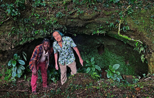 Patrick Blanc and his guide Florin emerging from a mossy cave, Amber Mountain, Madagascar, Aug. 2024