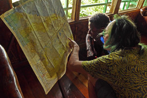 Patrick Blanc and his Papuan guide Chris, looking at the Sepik map, Karawari, Papua New Guinea, March 2016