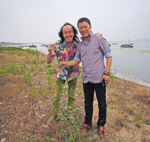 Patrick Blanc and Mr Meng holding a specimen of Cynanchum acutum ssp sibiricum on the new project site, Qingdao, China, July 2015