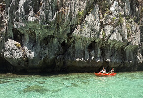 Patrick Blanc and Pascal Héni kayaking to observe Begonia elnidoensis on its vertical limestone cliff habitat facing the sea, El Nido, Palawan, Philippines, April 2026