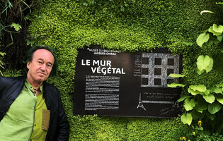 Patrick Blanc and the billboard explaining the concept of his vertical garden at the Quai Branly - Jacques Chirac Museum, Paris, May 2020