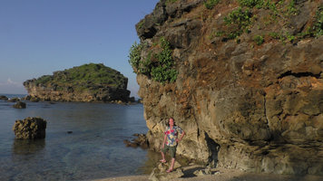 Patrick Blanc at the base of a seashore karst cliff covered by a creeping Ficus, Pacitan, Java, May 2018