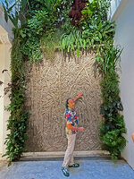 Patrick Blanc at the base of his vertical garden with the central fresco, Duxton, Singapore, Sept. 2023