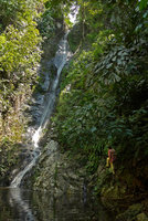 Patrick Blanc climbing on the rocks to observe plants around a waterfall, Pak Chom, Loei, Thailand, June 2016