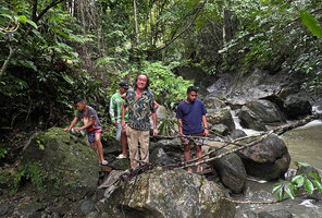 Patrick Blanc crossing a river with local guides, Taptap, Cebu, Philippines, Dec. 2024