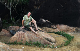 Patrick Blanc girded by a crown of Vitex rotundifolia, the unique main circular creeping stem producing axillary flowering upright shoots, Hue, Vietnam, Oct. 2018