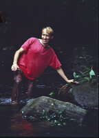 Patrick Blanc holding a specimen of Nephthytis poissonii and the rheophytic Anubias barteri fixed on rock in forest stream, Canopy Raft expedition, Campo, Cameroon, Oct. 1991