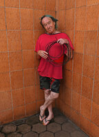 Patrick Blanc holding the 7 m long freely hanging barbed black shiny root of the new Cercestis species, Campo, Cameroon, Sept. 2023