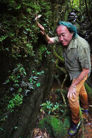 Patrick Blanc in a narrow forest canyon to observe a bright silver leaved form of Gravesia setifera, Mantadia NP, Madagascar, Aug. 2024