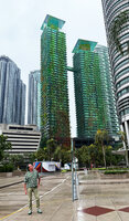 Patrick Blanc in front of Le Nouvel towers with the climbing plants that he installed ten years before, Kuala Lumpur, Sept. 2025