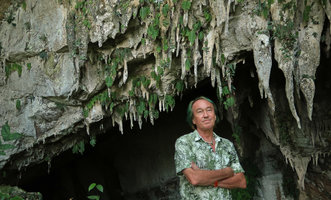 Patrick Blanc in front of the narrow endemic Monophyllaea pendula on stalactites at the entrance of Clearwater cave, Gunung Mulu NP, Sarawak, Borneo, Sept. 2018