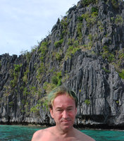 Patrick Blanc in front of the sea exposed limestone cliff habitat of Begonia elnidoensis, El Nido, Palawan, Philippines, Feb 2009