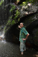 Patrick Blanc in the spray of the waterfall partly covered by Hydrostachys angustisecta, Prince Bernhard waterfall, Udzungwa NP, Tanzania, Jan. 2021