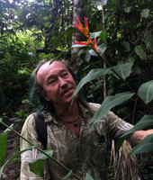 Patrick Blanc observing Heliconia hirsuta with zingiberoid leafy stems and bright red bracts, Calanoa, Leticia, Colombia, Nov. 2016