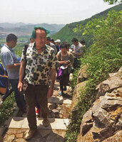 Patrick Blanc observing saxicolous plant species during a field trip with Chinese students in Dayang Shan, Suzhou, China, May 2014
