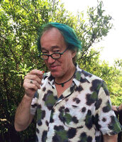 Patrick Blanc ready to eat a small forest fruit during a field trip in Dayang Shan, Suzhou, China, May 2014