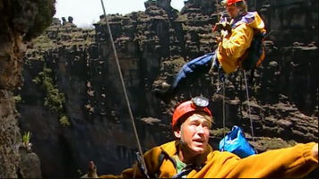 Patrick Blanc showing to Nicolas Hulot the plants growing on the vertical cliffs of the deep chasm, Kukenan Tepui, Venezuela, March 1999
