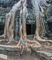 Patrick Blanc sitting among the roots of Tetrameles nudiflora, Ta Prohm, Cambodia, Dec. 2004