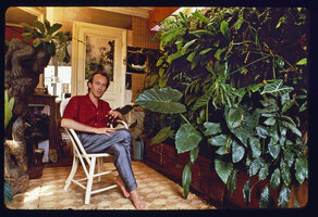 Patrick Blanc smoking at home in front of the depolluting plants of his vertical garden, Paris, 1988