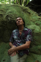 Patrick Blanc standing against travertine in a dry riverbed, Pacitan, Java, May 2018