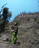 Patrick Blanc under a cliff and plateau covered by dry woodland, Victoria Falls, Zambia, Sept. 2017