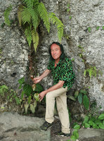 Patrick Blanc under ferns, holding the leafy stem of Kadsura scandens, Jidor waterfall, Malang, Java, April 2018