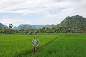 Patrick Blanc walking in rice fields surrounded by karst landscape, Rammang Rammang, Maros, South Sulawesi, June 2019