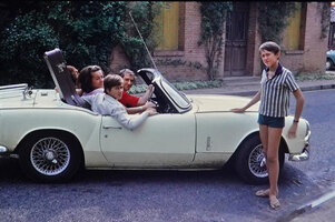 Patrick Blanc with his sisters and Alain Marty driving his Triumph car, Albefeuille Lagarde, France, Aug. 1967