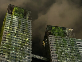 Upper parts of Le Nouvel towers at night with lianas and top vertical gardens by Patrick Blanc reflecting in the mirror ceiling, Kuala Lumpur, April 2023
